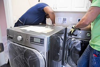 Electricians installing washer and dryer