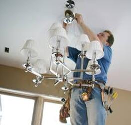 Electrician installing lighting